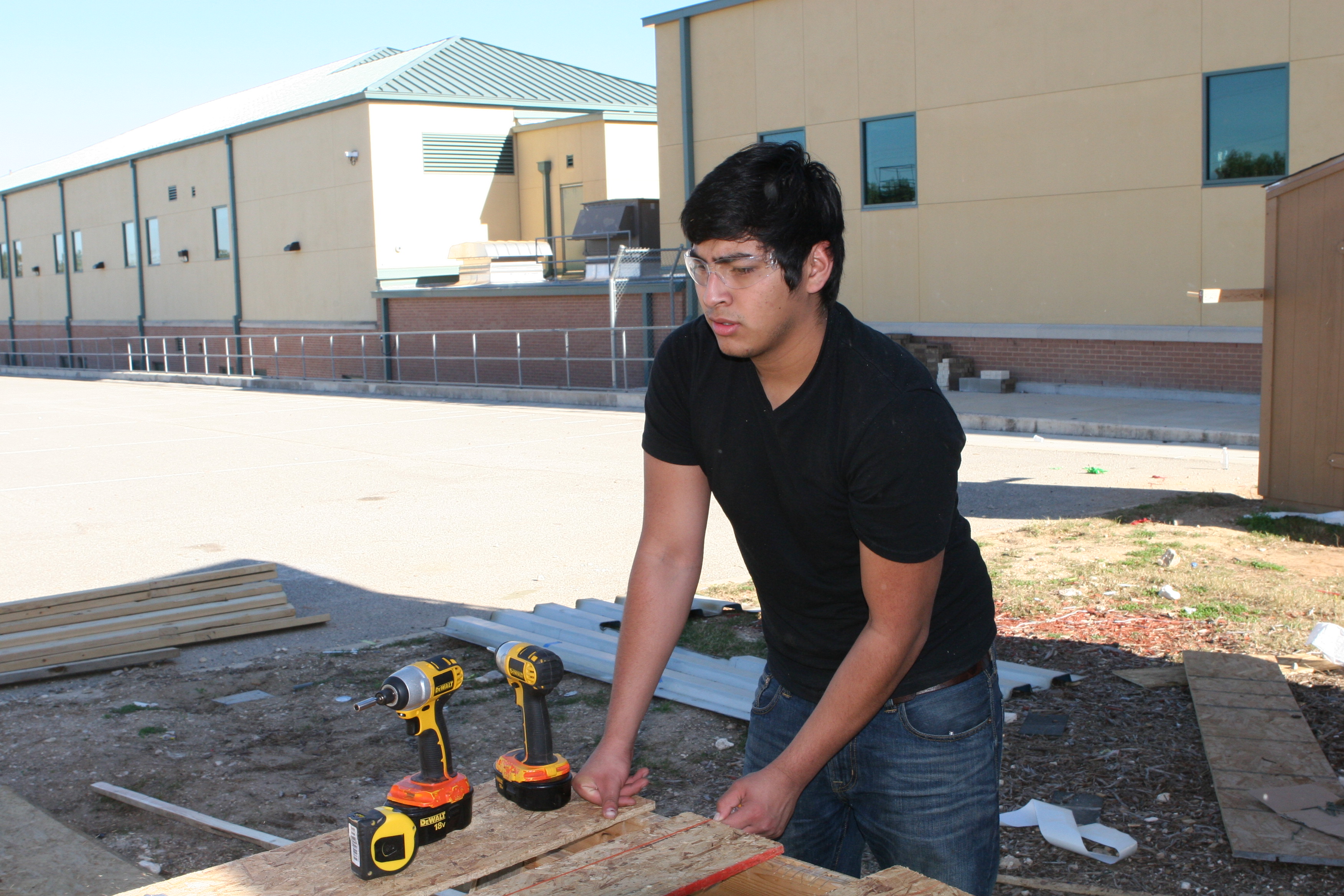 (Image) Robert Muniz builds a window frame for a micro-home at the Construction Careers Academy.