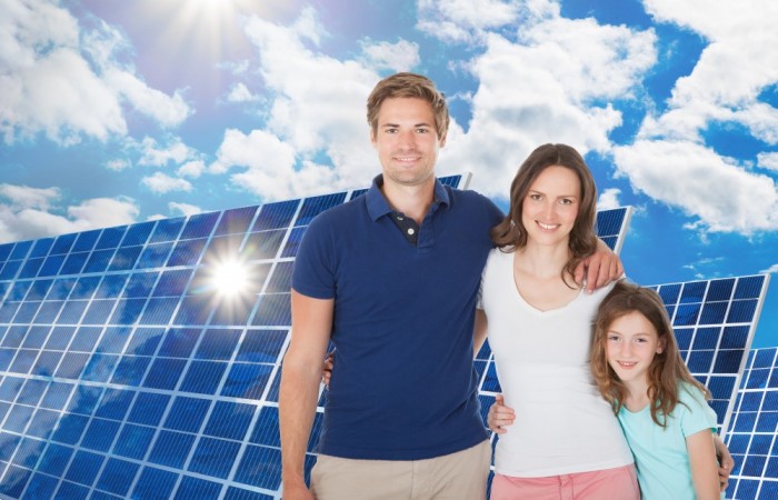 (Image) Family by solar panels