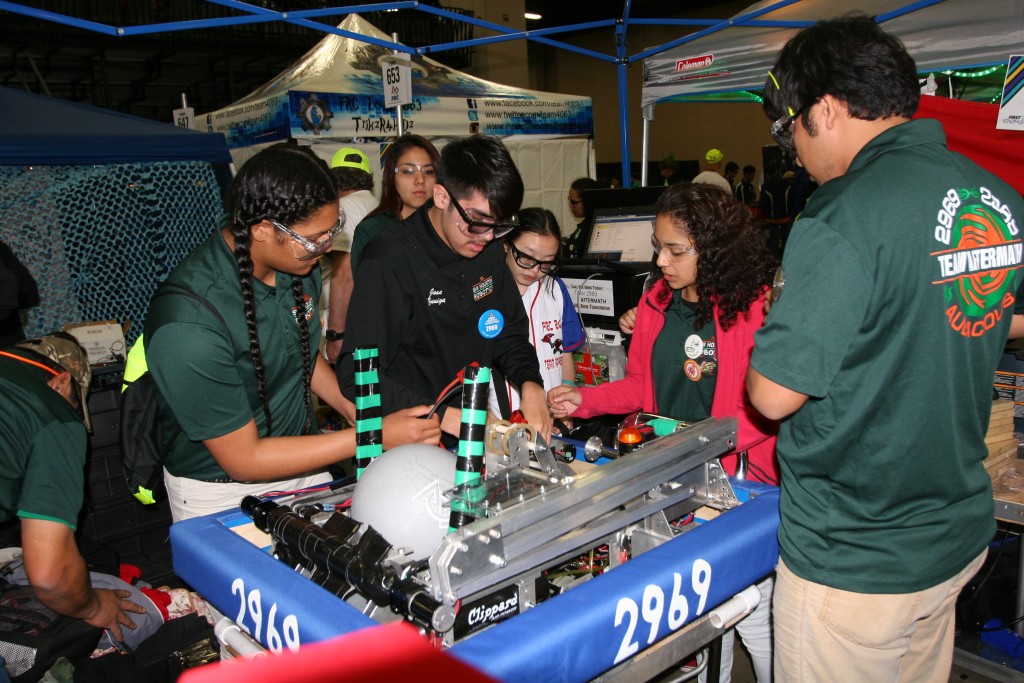 (Image) Team Aftermath troubleshoots a last-minute issue before competition.