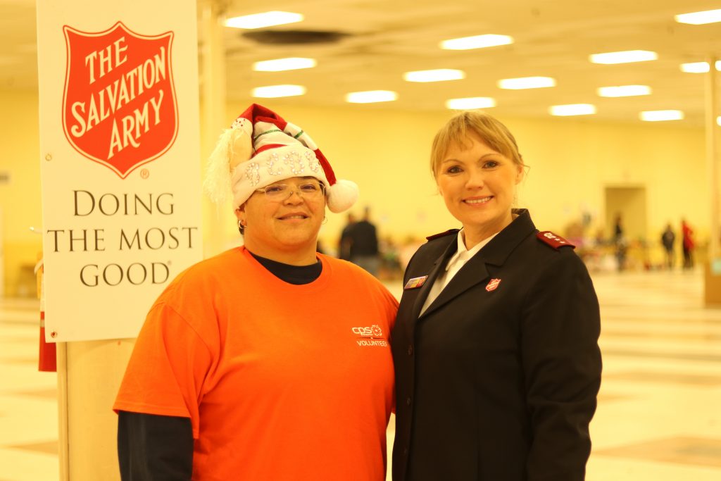 (Image) BeBe Bermudez (left), UED Foreman of our Northwest Service Center, and Salvation Army Captain Jana Griffin (right) help out during the final hours of toy distribution at Salvation Army's toy shop.