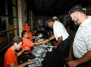 (Image) CPS Energy employees Johnny Garza and Kaycee Hickman help players check-in for the tournament. Nearly 30 CPS Energy employees and about 20 SAMMinistries volunteers provided valuable event support during the tournament.