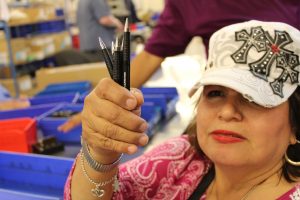 (Image) Alicia Cortinas, a general assembler like Raul, shows off some of her handy work at San Antonio Lighthouse. The Skilcraft pens are considered one of the best in the business. Despite having barely any vision, she's enjoyed a rewarding career at San Antonio Lighthouse.