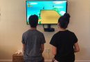 Two kids playing video games at home