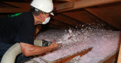 A photo of attic insulation being installed