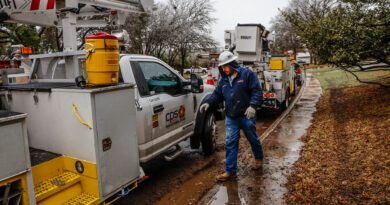 A photo of CPS Energy crew working in freezing rain to restore power