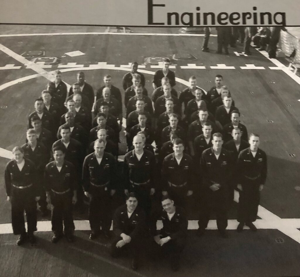 Art Dominguez, kneeling right, with other crewmembers aboard the Navy destroyer, USS O'Kane.